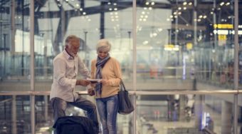 senior couple looking at documents in airport