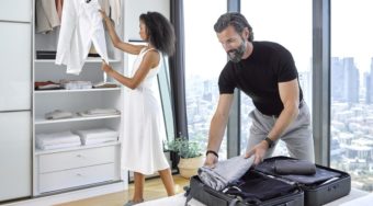man and woman packing a suitcase in a light, beautiful bedroom