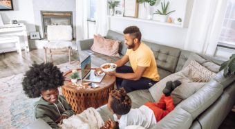 family relaxing and working in a vacation rental home living room