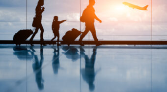 Silhouette of a young family with an airplane in the background